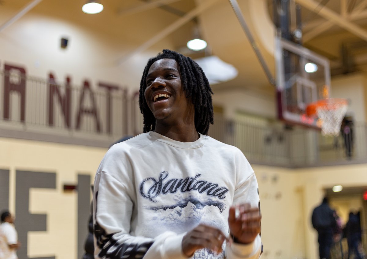 Basketball player laughing on the sideline